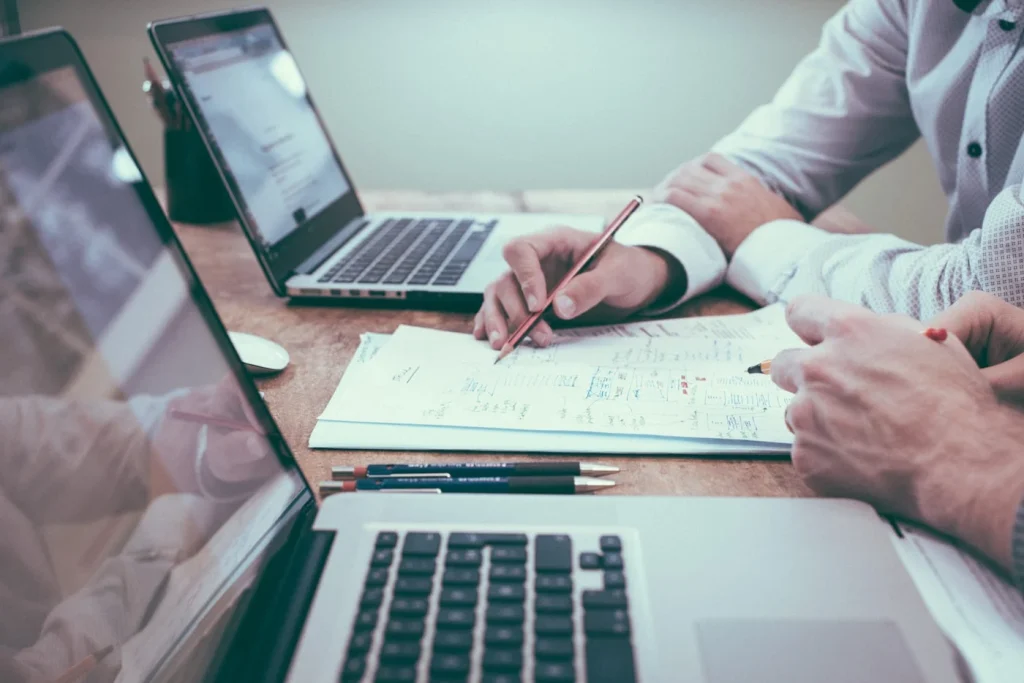 Professional reviewing documents and planning a product quotation request